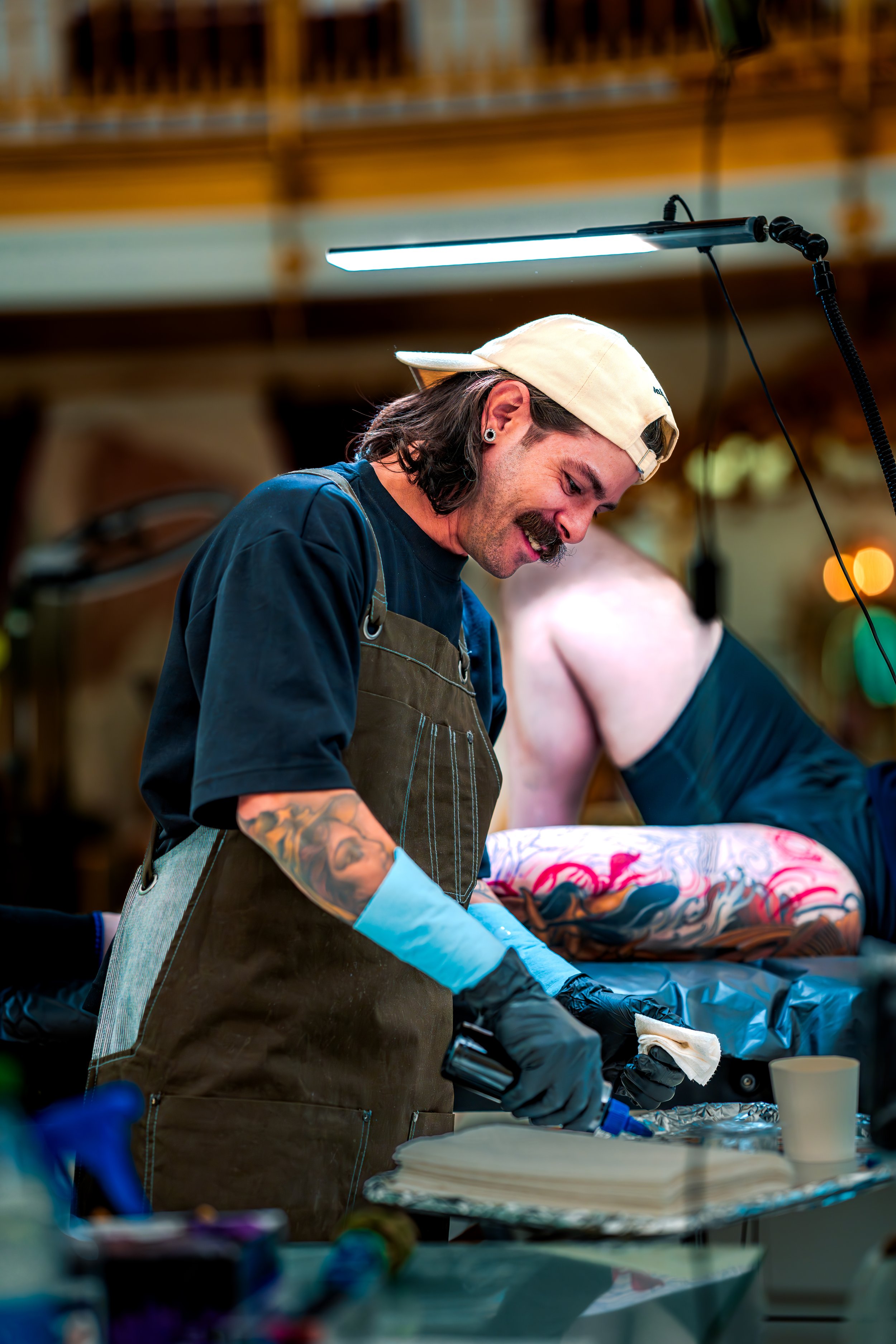 Gian Karle mid-session, working on a color sleeve, smiling at Almost Angels studio